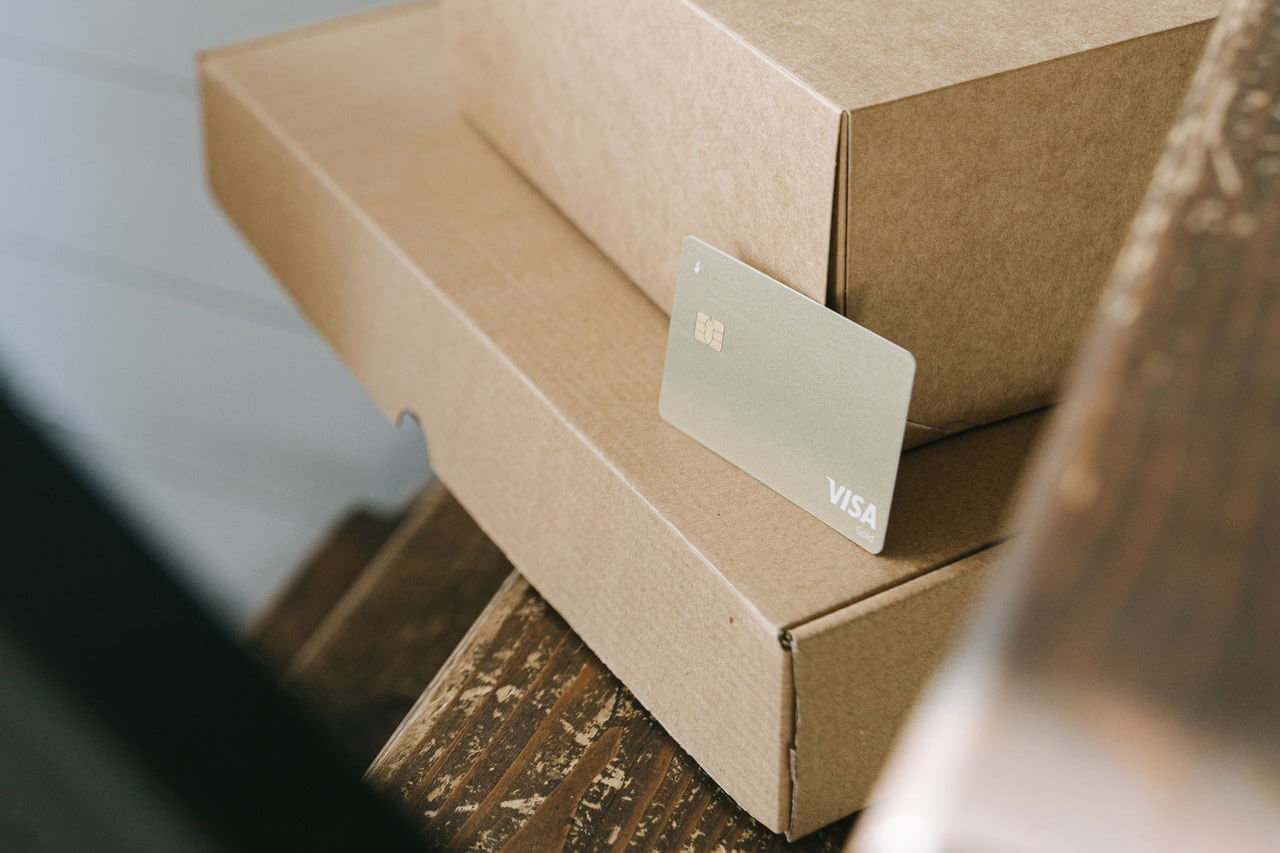Two minimalist and sustainable cardboard boxes with no brand and a payment card.